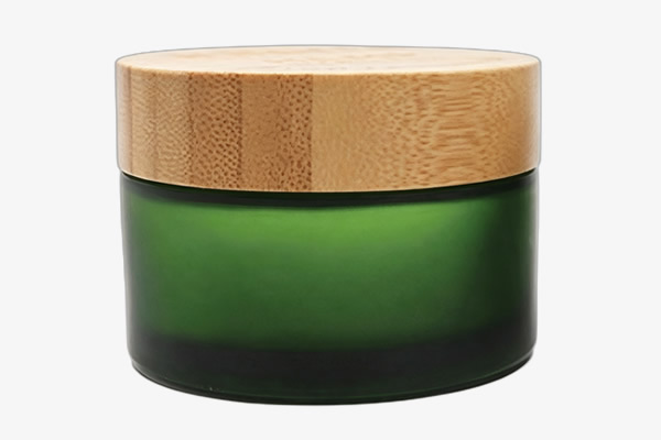 Glass facial cream bottle with sandblasted finish and bamboo lid